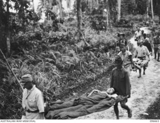 BONIS PENINSULA, BOUGAINVILLE. 1945-09-16. SERGEANT G.F. PALMER, ACCOMPANYING JAPANESE STRETCHER CASES BEING EVACUATED TO 17 FIELD AMBULANCE, SORAKEN, FOR MEDICAL TREATMENT. MEDICAL ATTENTION ..