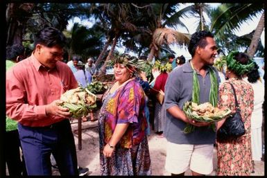 People carrying baskets of food, Rarotonga