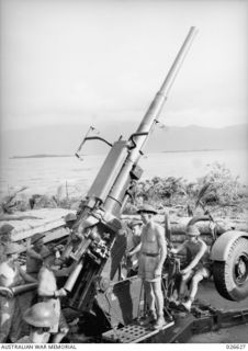 A HEAVY 3.7 INCH ANTI-AIRCRAFT GUN IN POSITION ON THE SHORES OF MILNE BAY NEAR GILI GILI, MANNED BY A CREW OF THE 2/6TH HEAVY ANTI-AIRCRAFT BATTERY, ROYAL AUSTRALIAN ARTILLERY