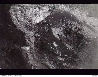 REINHOLD HIGHWAY, NEW GUINEA. 1943-08-22. ROCK FACE, THREE TO FOUR MILES ON THE BULLDOG SIDE OF JOHNSON'S GAP BEING WORKED BY SAPPERS ON THE 9TH AUSTRALIAN FIELD COMPANY, ROYAL AUSTRALIAN ENGINEERS