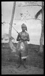 Portrait of woman in Samoan dress holding rod