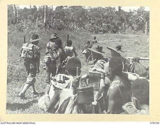 YAKAMUL, NEW GUINEA. 1945-01-09. MEMBERS OF THE 2/2ND INFANTRY BATTALION AND "JOCK FORCE" AND THEIR NATIVE CARRIERS LEAVING THEIR BASE CAMP AT THE START OF A 40 DAY PATROL THROUGH ENEMY OCCUPIED ..