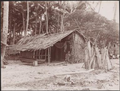 Man sitting at the entrance of a Longapolo house, Gaeta, Solomon Islands, 1906 / J.W. Beattie