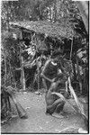 Pig festival, wig ritual, Tsembaga: men beautify themselves, feather valuables adorn headdress in background