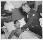 Pfc. James Oshiro being examined by Major Rotherwell in charge of physio-therapy at Moore General Hospital, Swannanoa, North Carolina. Pvt