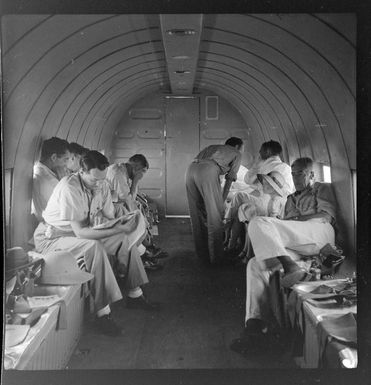 Qantas Empire Airways, passengers in flight, Rabaul to [Manus Island?], Papua New Guinea