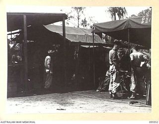 CAPE WOM, WEWAK AREA, NEW GUINEA, 1945-08-24. CRAFTSMAN C.J. BARRY (1) AND CRAFTSMAN E.R. MCRAE (2), MOTOR TRANSPORT STAFF OF 2/119 BRIGADE WORKSHOP. THEY WORK ON THE REPAIRING AND SERVICING OF ..