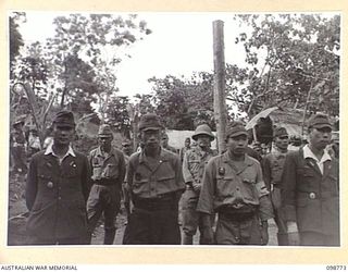 RABAUL, NEW BRITAIN. 1945-11-15. AN IDENTIFICATION PARADE OF SUSPECTED JAPANESE WAR CRIMINALS WAS ARRANGED BY THE WAR CRIMES COMMISSION AT HEADQUARTERS 11 DIVISION. SHOWN, JAPANESE TROOPS LINED UP ..