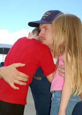 A US Navy (USN) Sailor is hug by his kids as friends and family members say goodbye to the crew of the USN Los Angeles Clas Submarine USS LA JOLLA (SSN 701) before the boat departs from its homeport at Pearl Harbor, Hawaii, for a six-month deployment. LA JOLLA is one of three specially configured attack submarines, equipped with a Dry Deck Shelter (DDS), that allows special operations forces including US Navy SEALs (Sea, Air, Land) to deploy from submarines