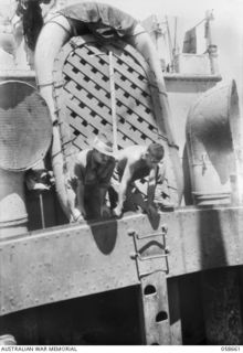 TERAPO, NEW GUINEA. 1943-09-16. SERGEANT R. HAYMAN, AUSTRALIAN MOVEMENT CONTROL, SUPERVISING THE DISCHARGE OF CARGO FROM THE "MULIAMA" TO A LANDING CRAFT VEHICLE, ANCHORED OFF THE LAKEKAMU RIVER