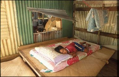 Child lying on mattress