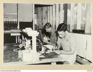 LAE, NEW GUINEA. 1944-11-09. NX170451 CORPORAL J.W. LETTON (1) AND Q271980 CORPORAL A.K. KILIMOFF (2) DENTAL MECHANICS, WORKING IN THE DENTAL LABORATORY OF THE 112TH AUSTRALIAN CONVALESCENT DEPOT