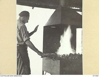 LABU POINT, LAE, NEW GUINEA. 1944-03-24. NX47123 CRAFTSMAN T. H. BROADBENT, WORKING IN THE BLACKSMITH'S SHOP AT THE 1ST WATERCRAFT WORKSHOP