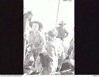 EN ROUTE TO KOIL ISLAND, NEW GUINEA, 1945-10-31. A VISIT TO KOIL ISLAND WAS ARRANGED BY THE RED CROSS FOR THE PURPOSE OF MEDICAL INSPECTION OF THE NATIVE INHABITANTS. THE VISITING PARTY CONSISTED ..