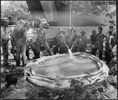 World War 2 New Zealand troops, bringing water ashore from a tank landing ship, Nissan Island, Papua New Guinea