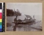 Men with fishing canoe on beach, Delena, Papua New Guinea, ca. 1905-1915