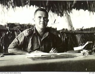 KILIGIA, NEW GUINEA, 1944-03-16. VX27 MAJOR-GENERAL A.H. RAMSAY, CBE, DSO, ED, GOC HEADQUARTERS, 5TH DIVISION, AT HIS DESK