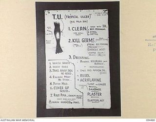 LAE AREA, NEW GUINEA, 1945-08-03. A "PIDGIN" ENGLISH CHART USED FOR THE INSTRUCTION OF NATIVE REGIMENTAL AID POST ORDERLIES. THE PHOTOGRAPH WAS MADE AT THE REQUEST OF HEADQUARTERS AUSTRALIAN NEW ..