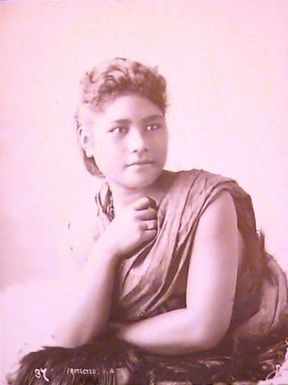 Samoan woman with hand raised to her throat