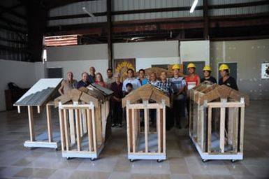NMTI students and staff, hardware store owners, FEMA FCO and FEMA Hazard Mitigation Staff, CARE staff, and the Governor's office representatives celebrating the completion of the models.