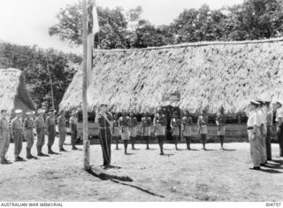 GOODENOUGH ISLAND, NEW GUINEA. 1944-01-01. ALLIED INTELLIGENCE BUREAU (AIB) PERSONNEL AT AIB HEADQUARTERS AT COLOURS. INCLUDED IN THE PHOTOGRAPH ARE LIEUTENANTS (SPECIAL BRANCH) C. W. DUKE-YONGE ..