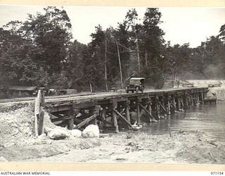 MAPE RIVER, NEW GUINEA, 1944-03-15. THE NO.2 PILE- BENT ONE WAY BRIDGE, WITH A LENGTH OF 320 FEET, WAS BUILT BY THE 870TH UNITED STATES AVIATION ENGINEER BATTALION IN SIX DAYS