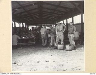MOEM, WEWAK AREA, NEW GUINEA, 1945-09-17. MEMBERS OF 2/4 ARMOURED REGIMENT DETACHMENT WITH 4 INFANTRY TROOPS WORKSHOP IN THE MEN'S MESS HUT WHICH HAS A CONCRETE FLOOR