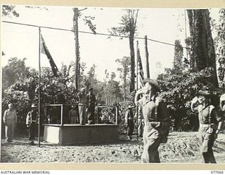 BOUGAINVILLE, 1944-11-21. MAJOR-GENERAL O. GRISWOLD, COMMANDING GENERAL, XIV CORPS, UNITED STATES ARMY TAKING THE SALUTE FROM MEMBERS OF THE 7TH AUSTRALIAN INFANTRY BRIGADE. WITH HIM ON THE DAIS IS ..