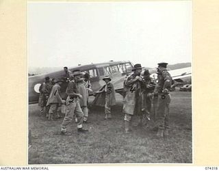 WAU, NEW GUINEA. 1944-07-02. DELEGATES OF THE EMPIRE PARLIAMENTARY DELEGATION BEING GREETED BY AUSTRALIAN ARMY OFFICERS ON THEIR ARRIVAL AT THE AIRSTRIP. IDENTIFIED PERSONNEL ARE:- VX61 LIEUTENANT ..