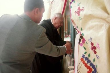 King Taufa'ahau Tupou IV, King of Tonga, entering church Vaine Mo'onia through a portal of fine mats