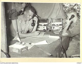 MOTUPINA POINT AREA, BOUGAINVILLE ISLAND. 1945-01-20. VX104258 LIEUTENANT A. RELPH (1), NX137021 LIEUTENANT L.M. PRIOR (2), AND VX148764 GUNNER S. INGRAM (3), CHECKING OVER THE PREVIOUS NIGHTS ..