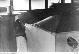 MILNE BAY. C.1943-04-14. DAMAGE CAUSED BY A BOMB WHICH PENETRATED THE BRIDGE STRUCTURE OF HMAS PIRIE BEFORE EXPLODING ON THE FORECASTLE. THE BOMB WAS DROPPED BY A JAPANESE AIRCRAFT WHEN THE ..