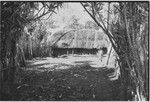 House enclosed by fence, boy