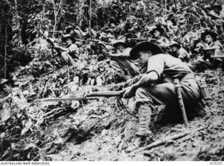 1943-07-08. New Guinea. Wau-Mubo Area. An Australian patrol moves out along the Mubo Track in a forward area