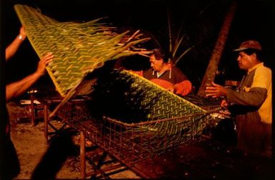 Men preparing tubs for banquet food, Rarotonga