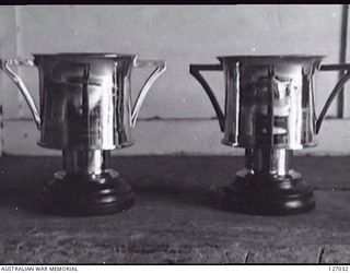 BRISBANE, QLD. 1946-04-06. SPORTING TROPHIES PRESENTED BY THE DEPUTY ASSISTANT DIRECTOR OF AMENITIES, QLD LINES OF COMMUNICATION AREA, INTERSTATE RUGBY LEAGUE CUP, BOUGAINVILLE, 1945-09, WON BY QLD ..