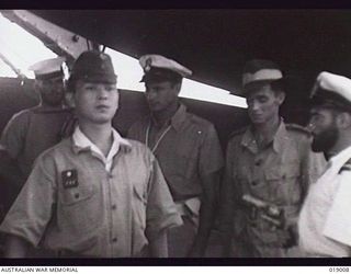 Bougainville. August 1945. Japanese envoy Captain Takenaka, was conveyed on HMAS Lithgow to Lieutenant General S. G. Savige's headquarters to receive surrender terms. The envoy was searched on ..