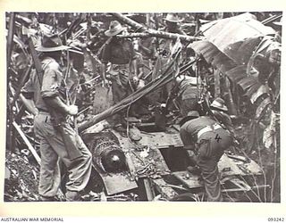 CHABAI/SORAKEN AREA, BOUGAINVILLE, 1945-06-16. BRIG J. R. STEVENSON, COMMANDER 11 INFANTRY BRIGADE (2), INSPECTING A TYPE 89 JAPANESE TANK FOUND BY C COMPANY, 26 INFANTRY BATTALION (AIF) (REAR ..