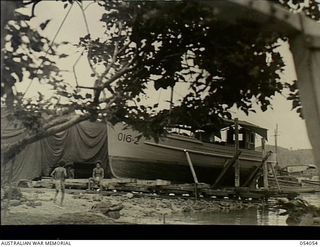 Kwiara, New Guinea. 1943-07-06. The Royal Australian Air Force vessel O16-2 on the slips for repairs at the 1st Australian Water Transport Group (Small Craft) Maintenance Base situated on the China ..