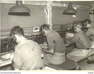 LAE AREA, NEW GUINEA. 1945-02-06. AUSTRALIAN SERVICE PERSONNEL OPERATING TRANSMITTING KEYS AT THE SIGNALS TRANSMITTING CENTRE, HEADQUARTERS, 19TH LINES OF COMMUNICATION SIGNALS, HEADQUARTERS, FIRST ..