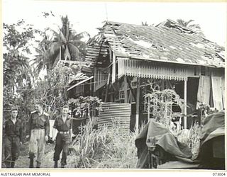 MADANG, NEW GUINEA. 1944-04-25. THE RUINS OF THE OLD HOTEL MADANG. THE HOTEL IS NOW USED BY 8TH INFANTRY BRIGADE SIGNALS