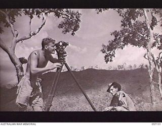 SEVENTEEN MILE, NEW GUINEA. 1943-09-23. VX101080 SAPPER (SPR) M. K. PROWSE (LEFT) AND NX140979 SPR B. J. HOOKER OF THE 2/1ST AUSTRALIAN ARMY TOPOGRAPHICAL SURVEY COMPANY DOING FIELD WORK WITH A ..