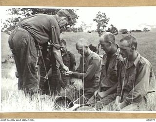 RAMU VALLEY, NEW GUINEA. 1943-10-20. SX11061 PADRE H. NORMAN, (CHURCH OF ENGLAND), ADMINISTERS HOLY COMMUNION TO VX119543 PRIVATE SMITH (2); CORPORAL R. JACKSON (3); CORPORAL G.W. LANE (4); ..