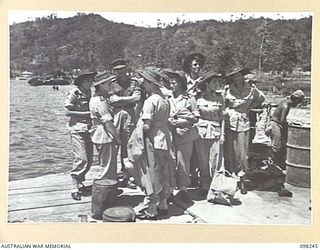 RABAUL, NEW BRITAIN. 1945-10-26. AUSTRALIAN ARMY NURSING SERVICE SISTERS, ARRIVING TO STAFF 118TH AUSTRALIAN GENERAL HOSPITAL, ON THE WHARF AFTER LANDING FROM MOTOR LAUNCH. THE SISTERS WERE FLOWN ..