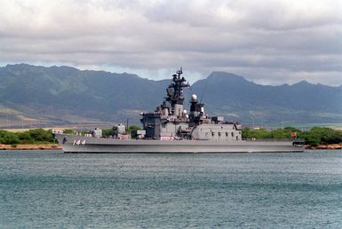 A port view of the Japanese destroyer KURAMA (DD 144) departing Pearl Harbor through the channel.