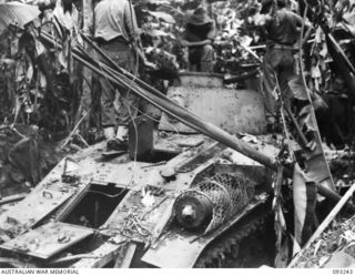 CHABAI/SORAKEN AREA, BOUGAINVILLE, 1945-06-16. BRIG J.R. STEVENSON, COMMANDER 11 INFANTRY BRIGADE, INSPECTING A TYPE 89 JAPANESE TANK FOUND BY C COMPANY, 26 INFANTRY BATTALION (AIF). (REAR ..