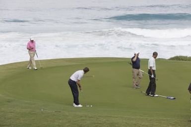 Barack Obama plays golf with Prime Minister Najib Razak, Joe Paulsen, and Mike Brush in Kaneohe Bay, Hawaii, December 24, 2014