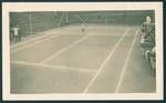 Don Honeysett and Jim Graham (not shown in photograph) playing tennis with spectators on side of court, Rabaul, New Guinea, c1929 to 1931