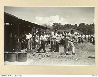 LAE, NEW GUINEA. 1944-05-24. WALKING PATIENTS AT THE 2/7TH GENERAL HOSPITAL FILING PAST MESS ORDERLIES DURING THE MESS PARADE. ALL WALKING PATIENTS AT THE HOSPITAL ATTEND THE PARADE. IDENTIFIED ..