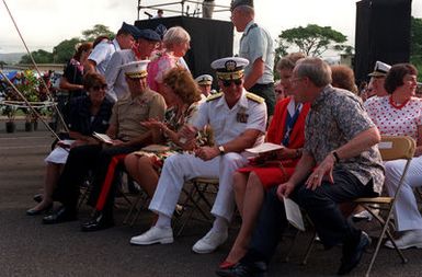 Front row guests LGEN Royal N. Moore, Commanding General, 3rd Marine Aircraft Wing; ADM Robert J. Kelly, Commander in CHIEF, U.S. Pacific Fleet; and Secretary of the Navy H. Lawrence Garrett III and their wives chat before Survivor's Day ceremonies at the USS ARIZONA Memorial Visitors Center. The event honors the sailors and Marines of the battleships that were sunk or damaged in the Dec. 7, 1941, attack on Pearl Harbor